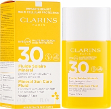 Kup Przeciwsłoneczny fluid do twarzy - Clarins Fluide Solaire Mineral Visage SPF 30
